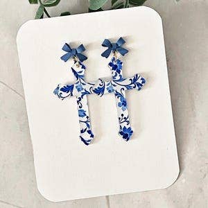 Floral Cross Dangle Earrings: Blue Bow Accent